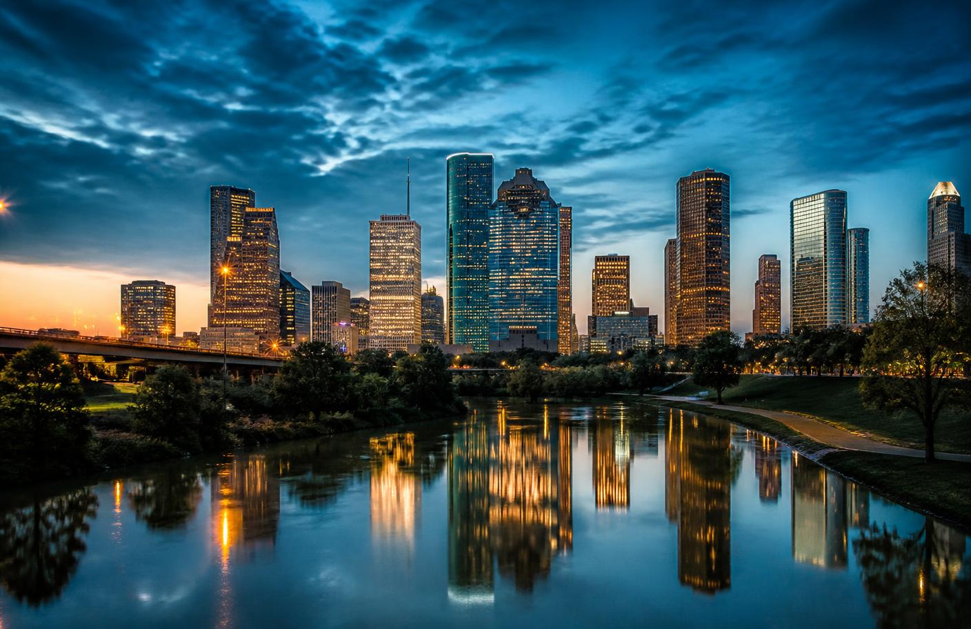 Buffalo Bayou path with the Downtown Houston skyline behind it at dusk